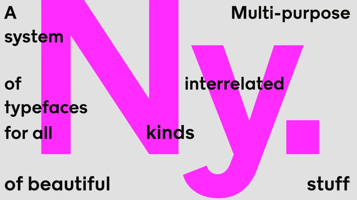 Eye-level shot of the letters 'N' and 'Y' in magenta, surrounded by black text on a gray background for a typography design.