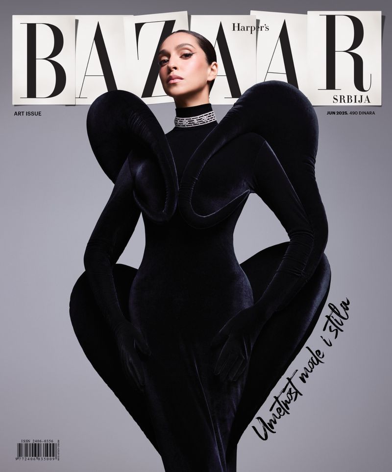 Magazine cover featuring a woman in a sculptural black dress with dramatic sleeves against a gray background, Harper's Bazaar Serbia.