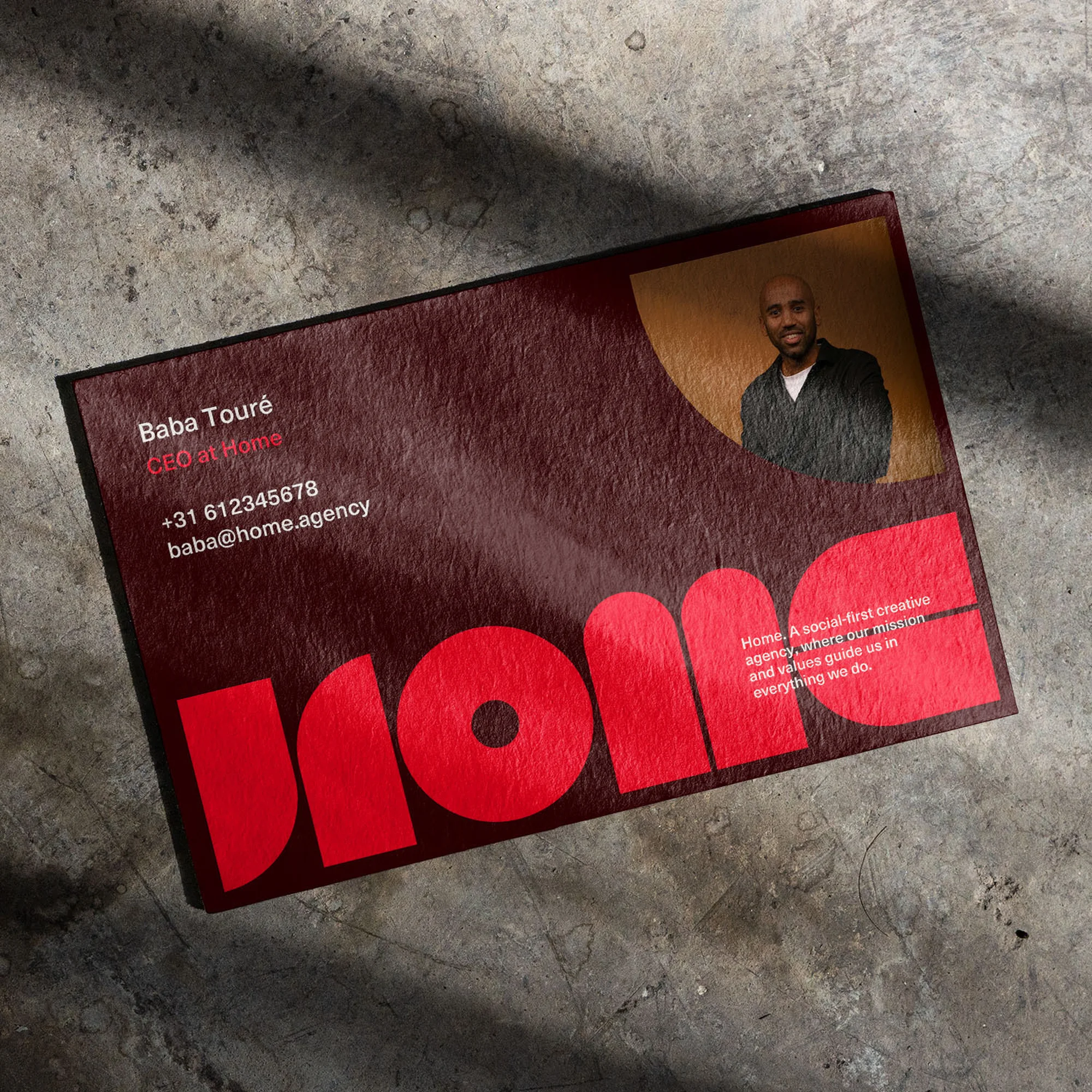 Promotional business card featuring a portrait of Baba Touré, CEO at Home, with contact details, and the word 'Home' in a bold red font.