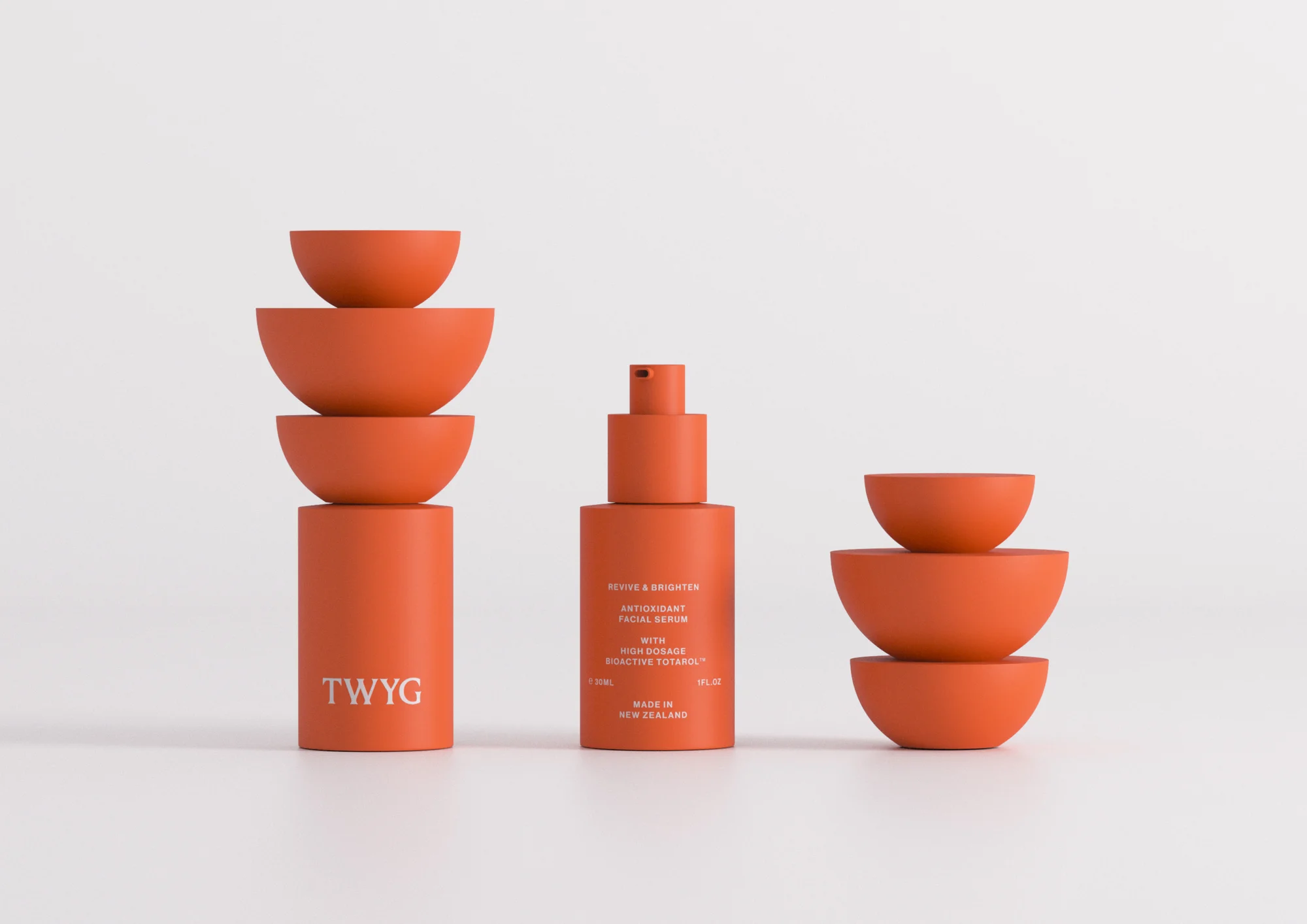 Product shot of TWYG Revive & Brighter Antioxidant Facial Serum with stacked terra cotta bowls against a clean white background.