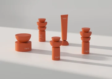 Terracotta cosmetic packaging and sculpted stacked objects arranged on a light surface with long shadows