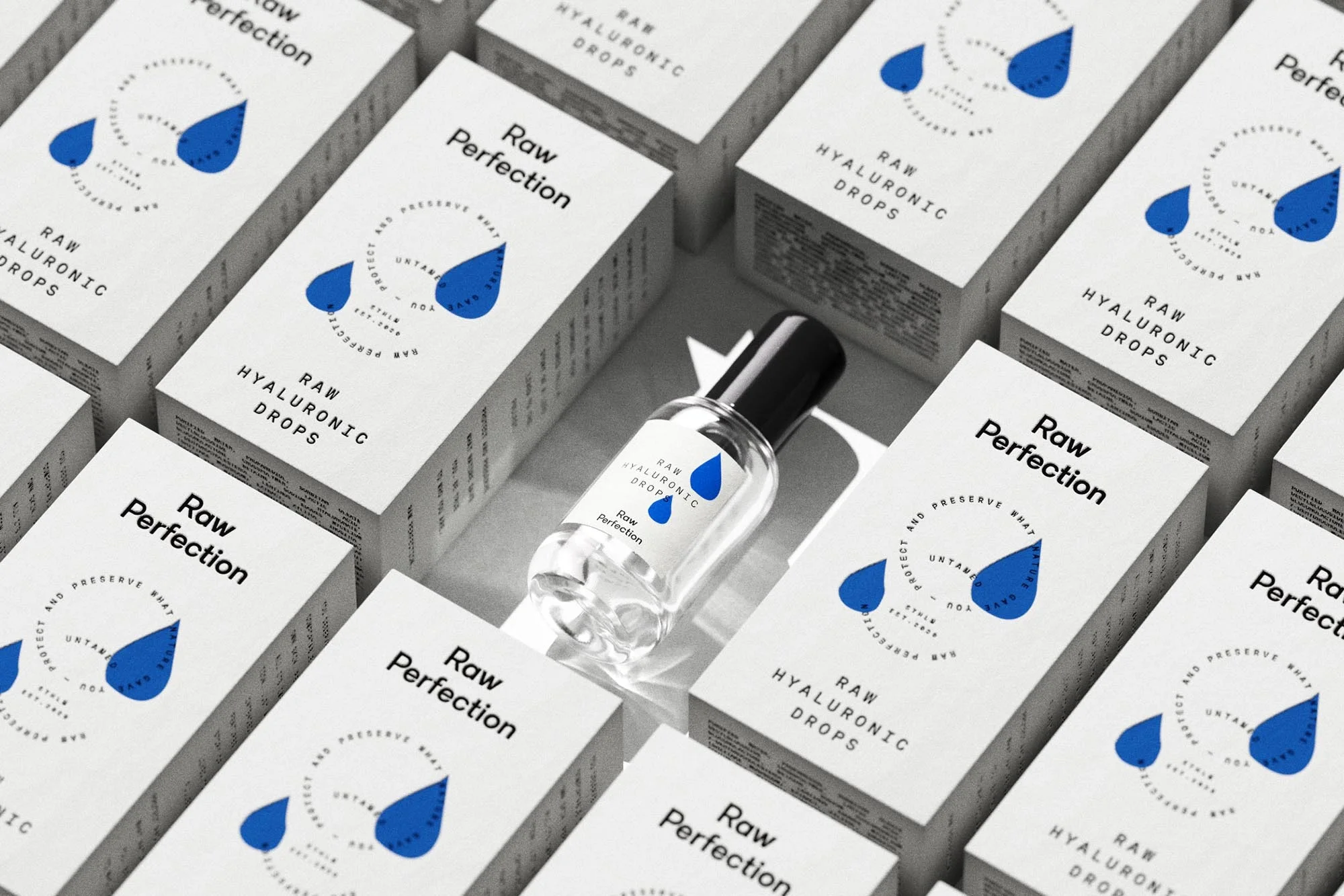 Close-up studio shot of Raw Perfection Hyaluronic Drops product packaging, featuring a bottle and multiple boxes on a neutral surface.