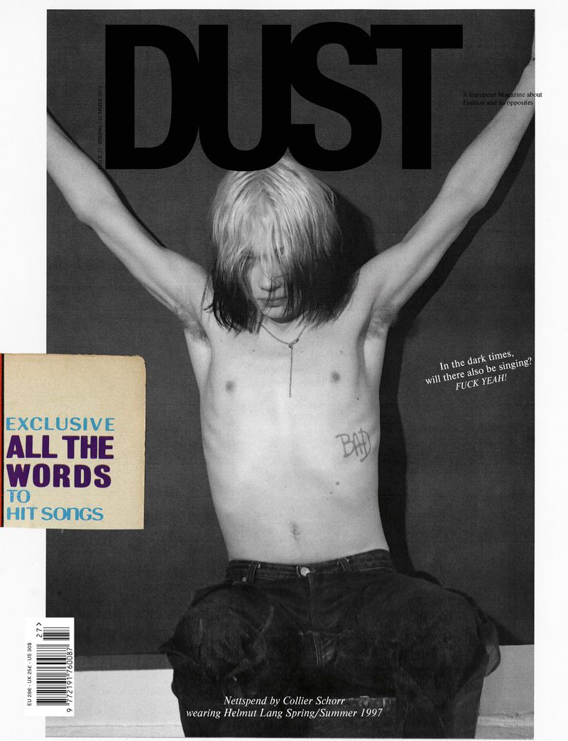 Black and white fashion magazine cover featuring a shirtless adult male model with platinum and dark hair, wearing jeans.