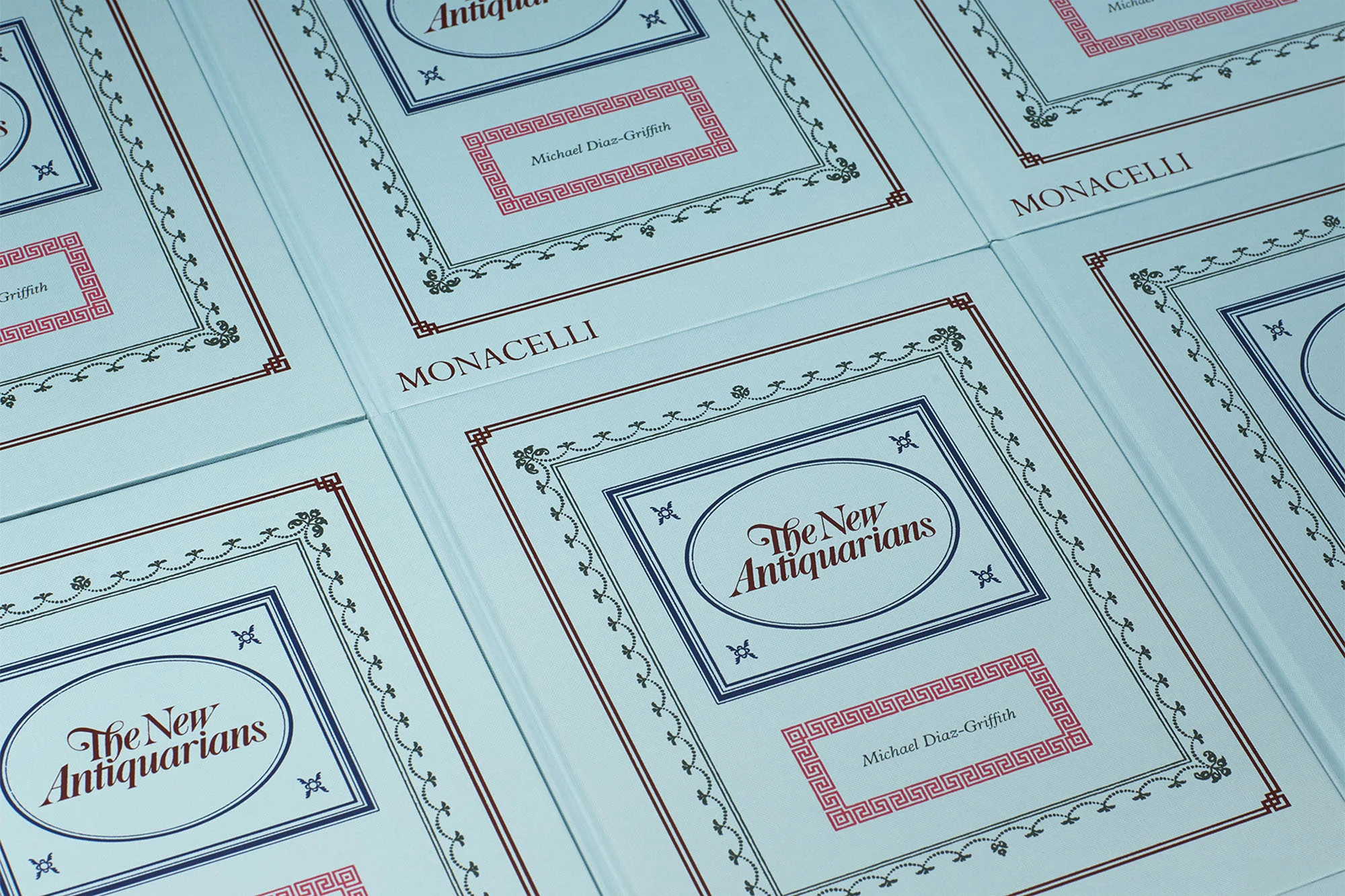 Multiple copies of the book 'The New Antiquarians' by Michael Diaz-Griffith, published by Monacelli, featuring decorative borders and text.