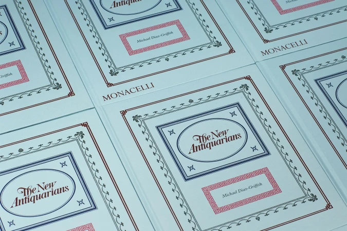Multiple copies of the book 'The New Antiquarians' by Michael Diaz-Griffith, published by Monacelli, featuring decorative borders and text.