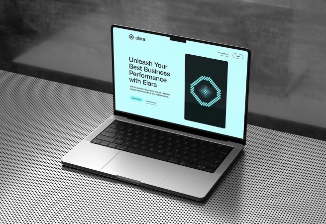 Silver laptop displaying 'Elara' homepage with sleek design, featuring a grid background and modern geometric screen graphic.