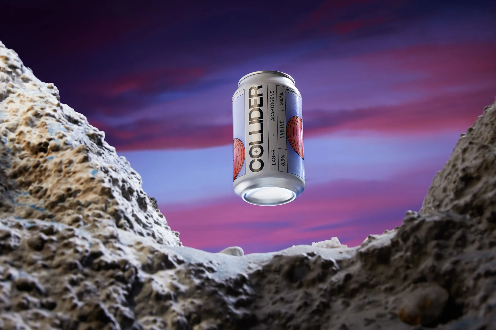 Silver Collider beverage can against a vivid pink and purple sky, resting on a cratered, rocky surface.