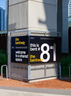 The Bentway brand identity signage mounted on a concrete pillar with wire mesh fencing and typography reading this is bent 81