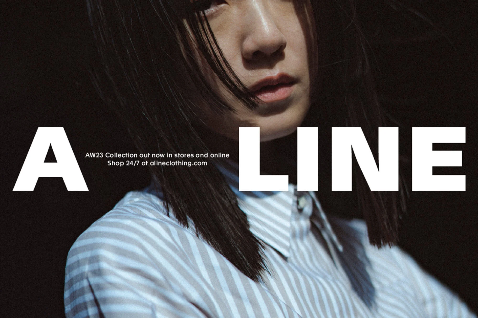 Fashion ad featuring a woman with dark hair wearing a striped shirt, alongside large text promoting 'A Line' clothing.