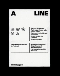 Close-up of a white fabric clothing label featuring black typography for A LINE, showing care instructions and material composition.