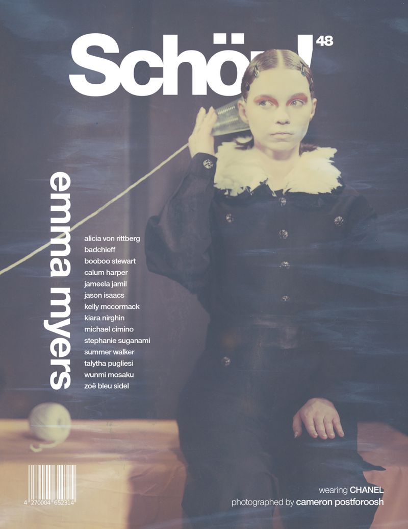 Magazine cover features a model in a dark coat with a ruffled collar, holding a tin can to her ear, with magazine text and logos.