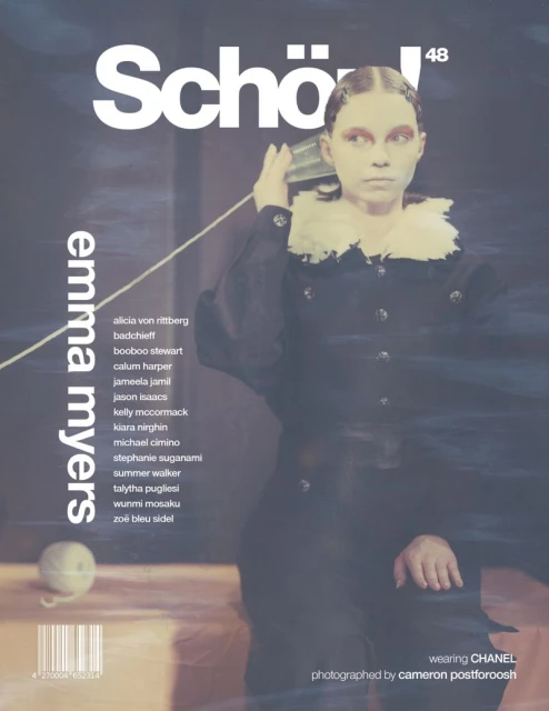 Magazine cover features a model in a dark coat with a ruffled collar, holding a tin can to her ear, with magazine text and logos.