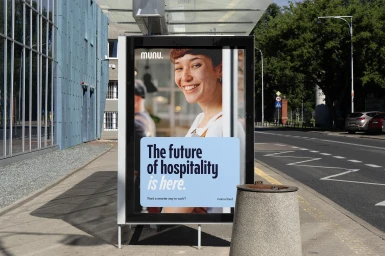 Munu brand identity billboard advertisement on a city street showing a smiling woman and promotional text