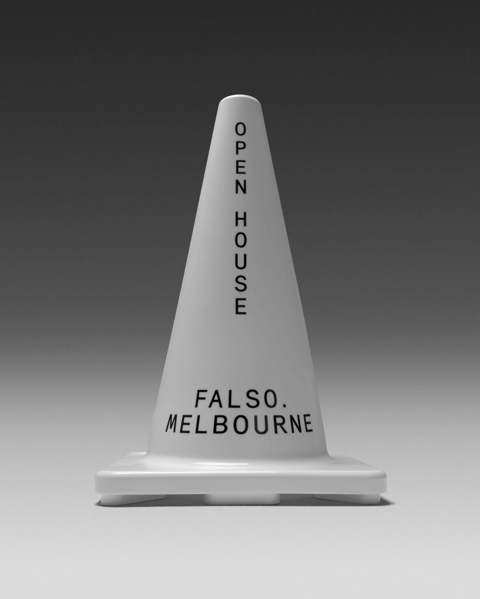 Monochrome studio shot of a white traffic cone with 'Open House' and 'Falso Melbourne' text on a neutral gray background.