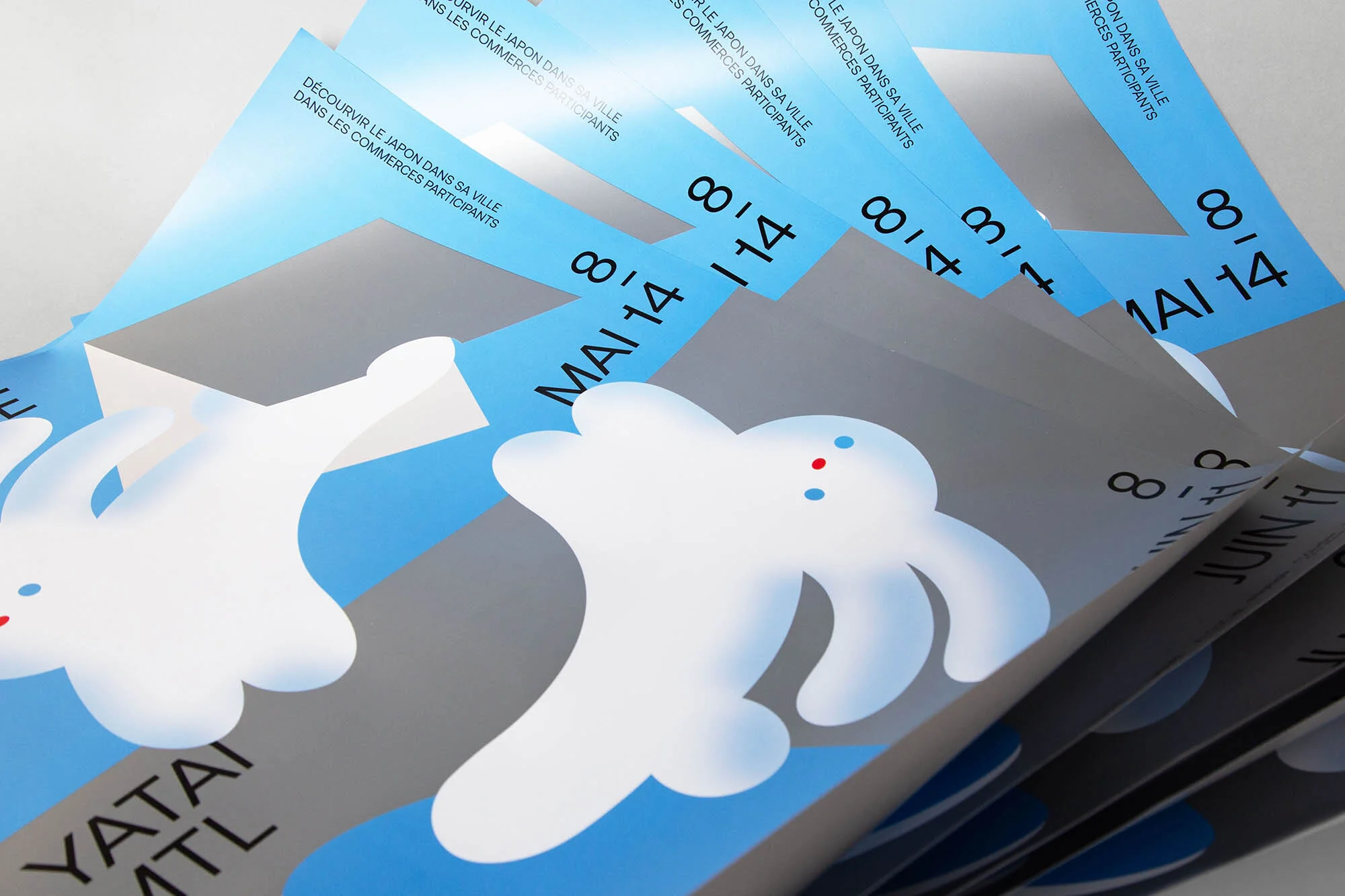 Stack of event posters featuring stylized white rabbit figures on a grey background with blue accent stripes and event dates.