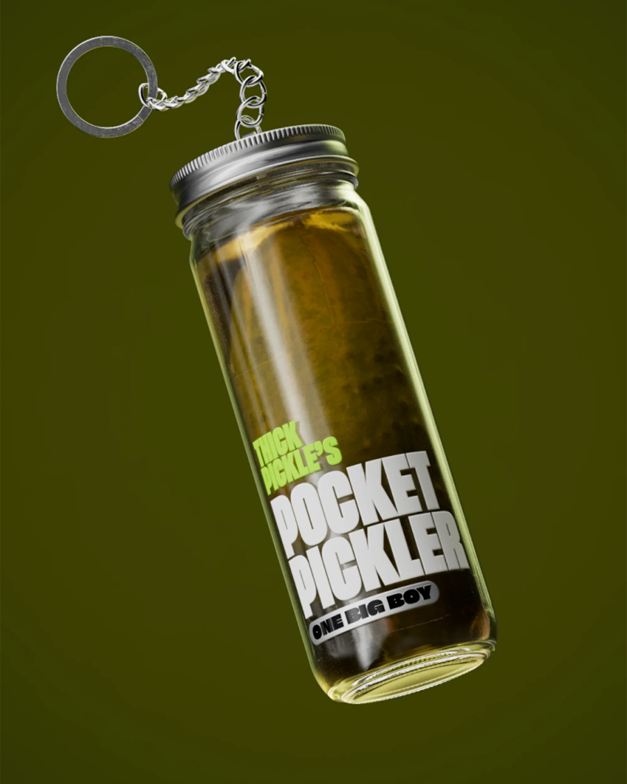 Glass jar keychain with a silver lid and keyring attached, containing a liquid and labeled with text on a solid green background.