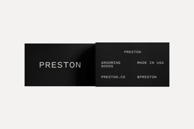 Two black business cards displaying the brand name 'Preston,' with additional details like 'Grooming Goods' and website information.
