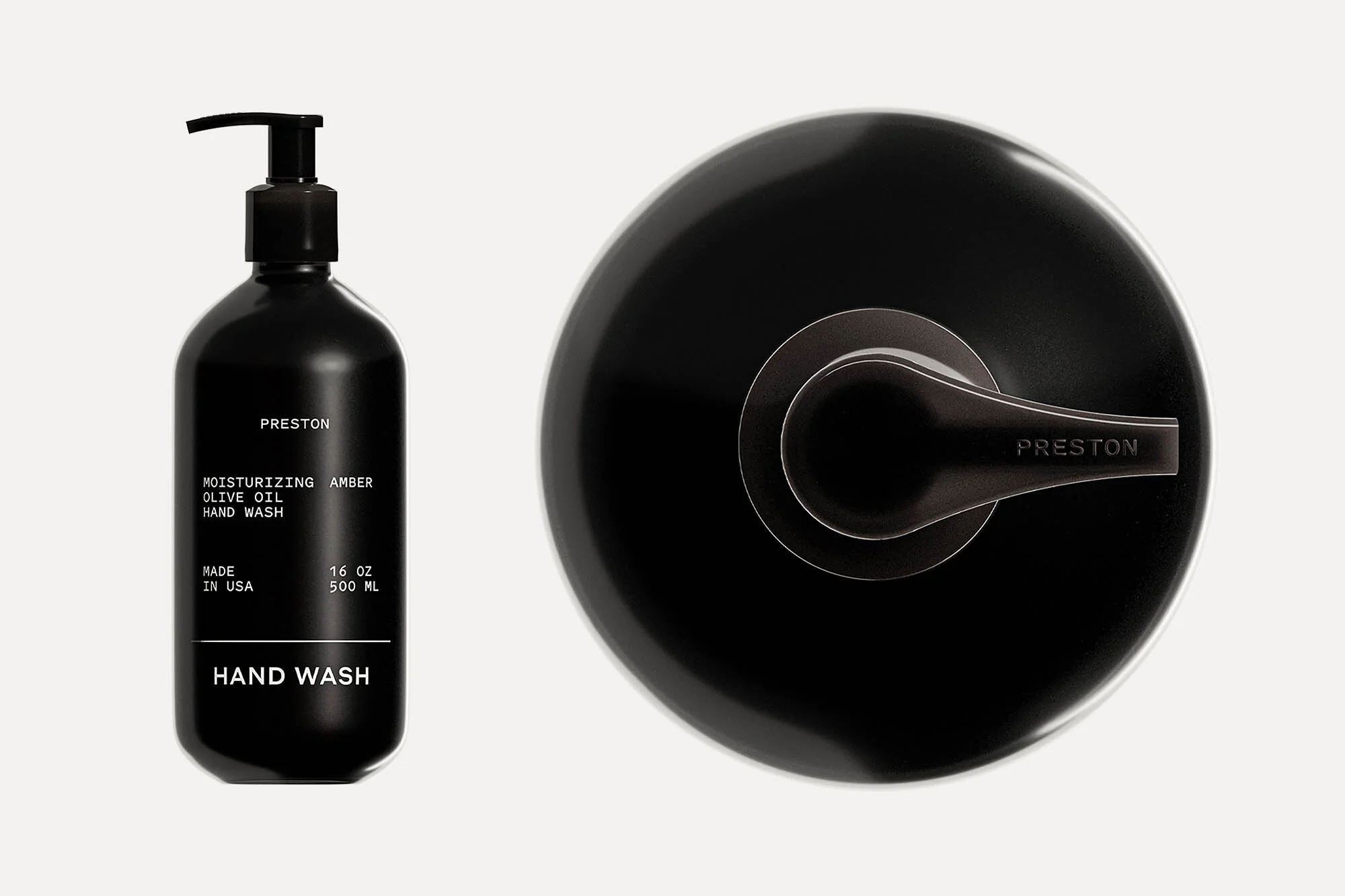 A black Preston hand wash bottle with a pump dispenser sits next to a modern, minimalist black metal shower faucet on an off-white surface.