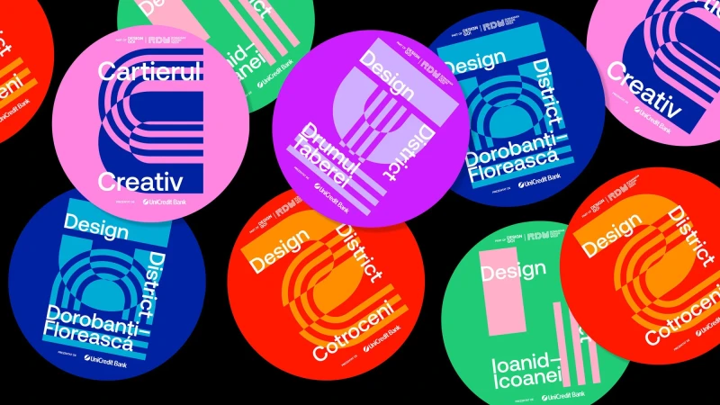 Graphic design featuring colorful round stickers with text and abstract shapes on a black background, promoting Design District.