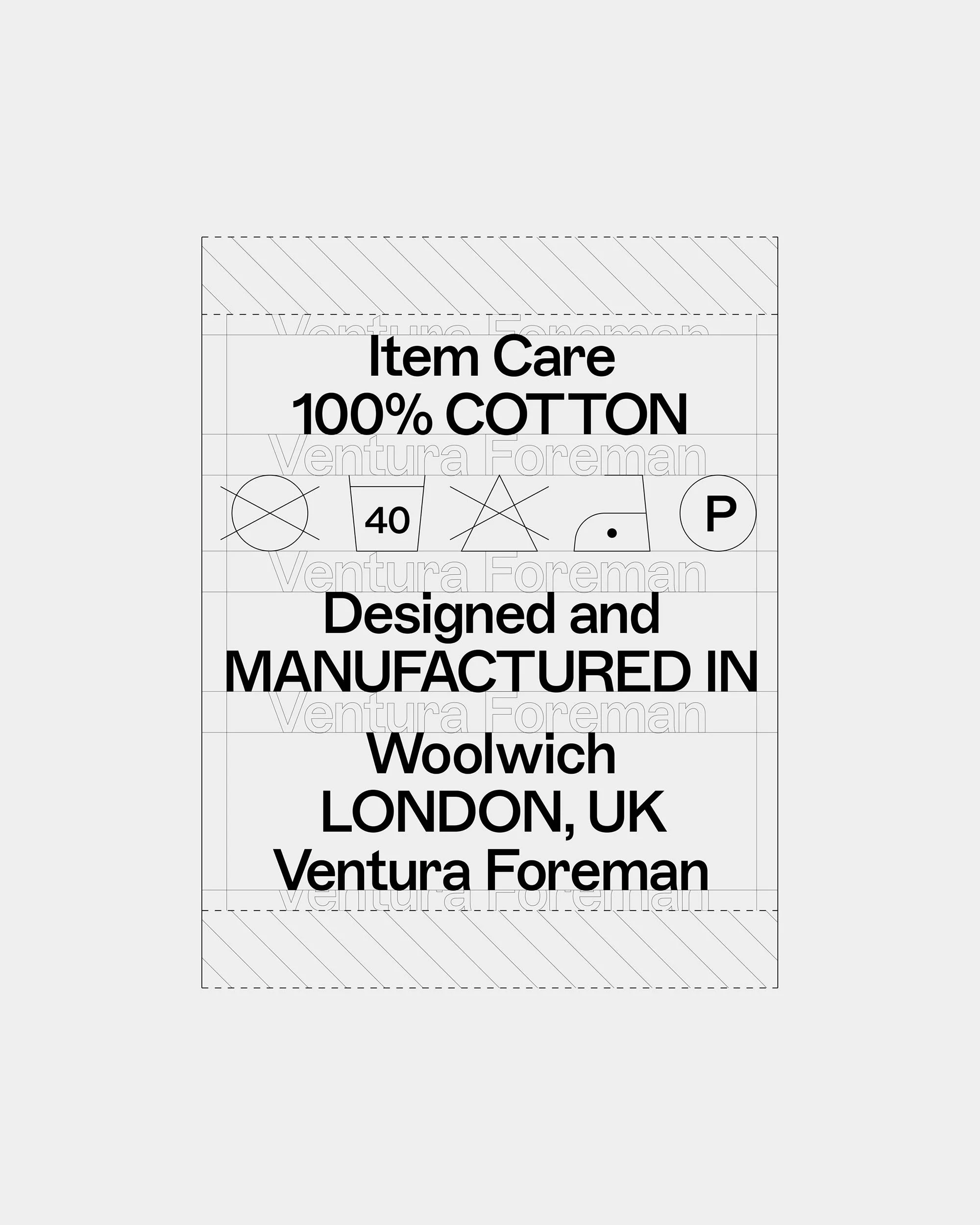 Close-up of a garment care label indicating '100% COTTON,' designed and manufactured in Woolwich, London, UK by Ventura Foreman.