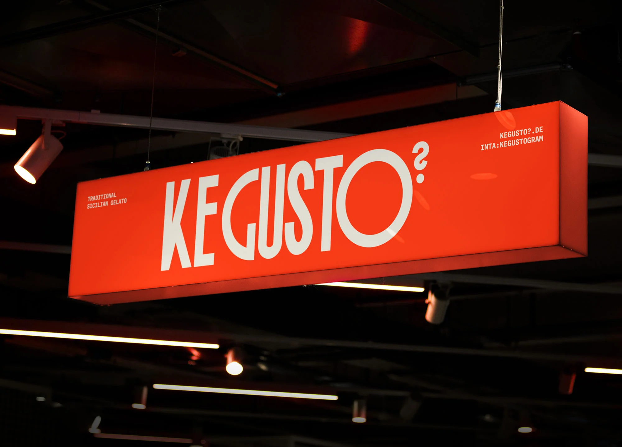 Illuminated orange sign for KE GUSTO? advertises traditional Sicilian gelato with a website and Instagram handle displayed.