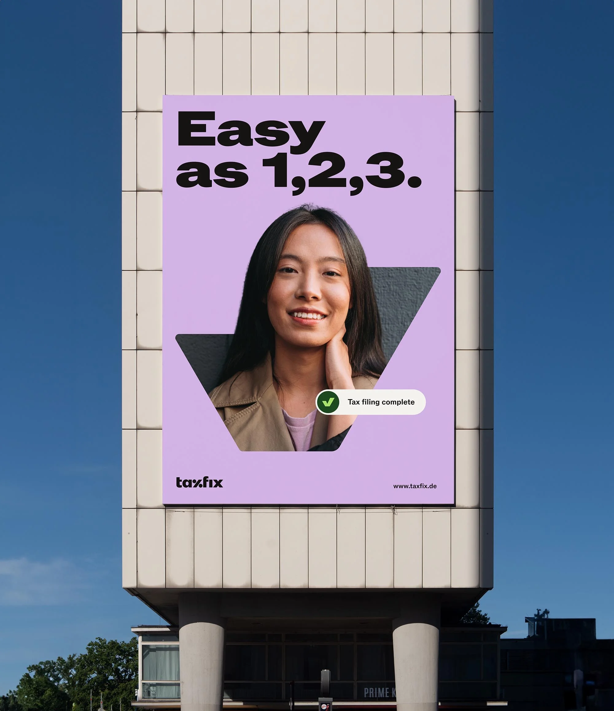 Outdoor advertising billboard featuring a smiling woman and the text 'Easy as 1,2,3' for Taxfix, a tax filing service.