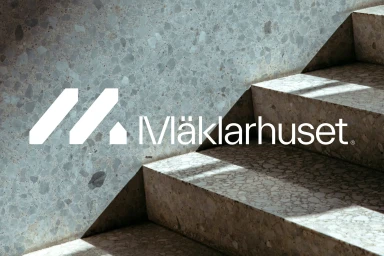 White Maklarhuset brand logo overlaid on a modern terrazzo staircase with natural light shadows
