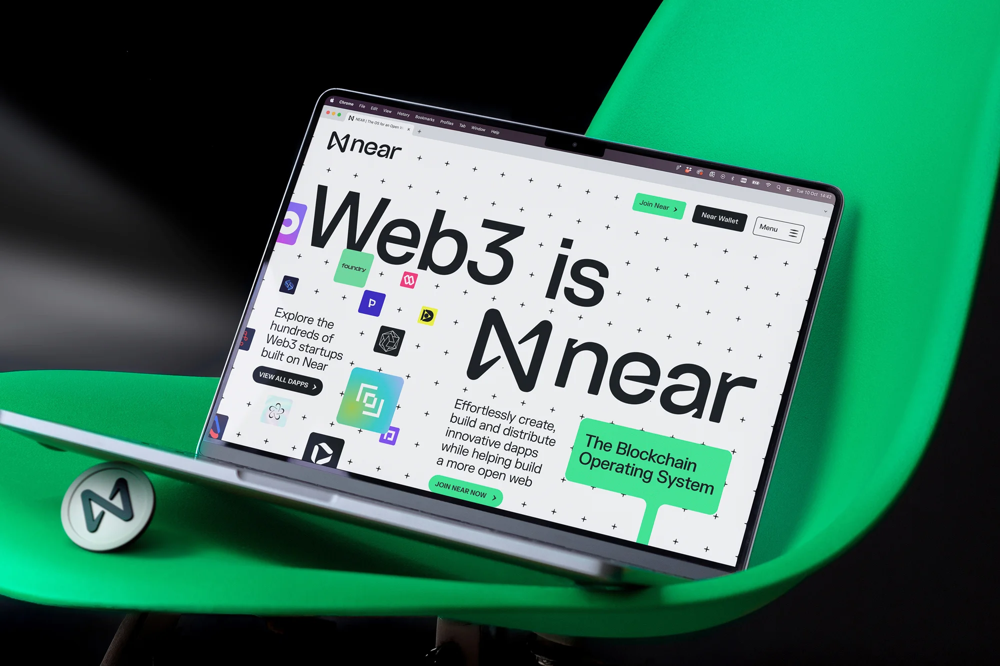 Laptop on a green chair displaying the Near Web3 website, featuring a clean design, modern interface, and Web3 branding.