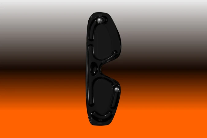 Close-up of dark glasses frames on a gradient backdrop ranging from grey to dark orange, with a side view highlighting the frame design.