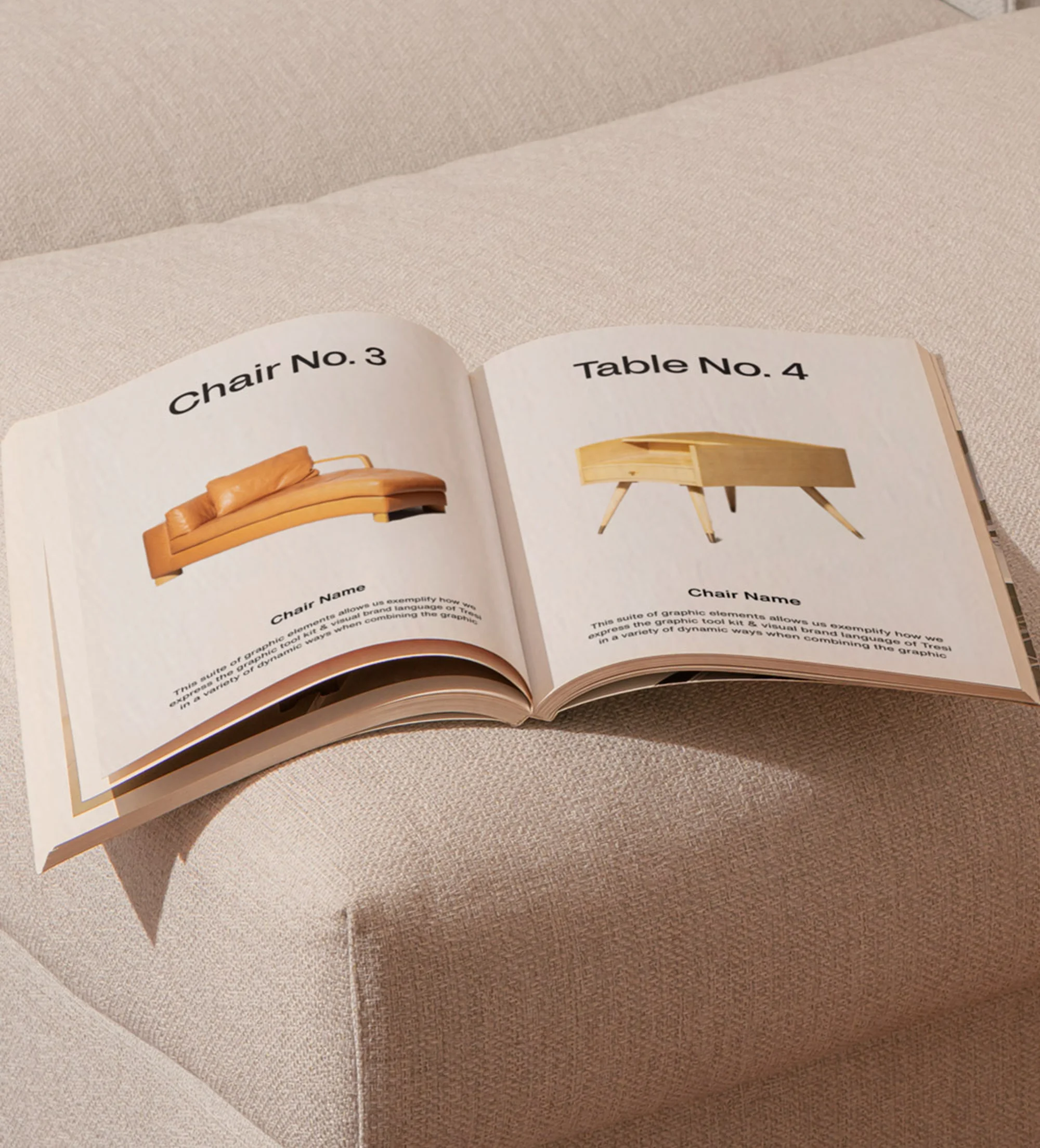 Open book on a textured beige surface, featuring product designs with chair and table schematics and descriptions on facing pages.