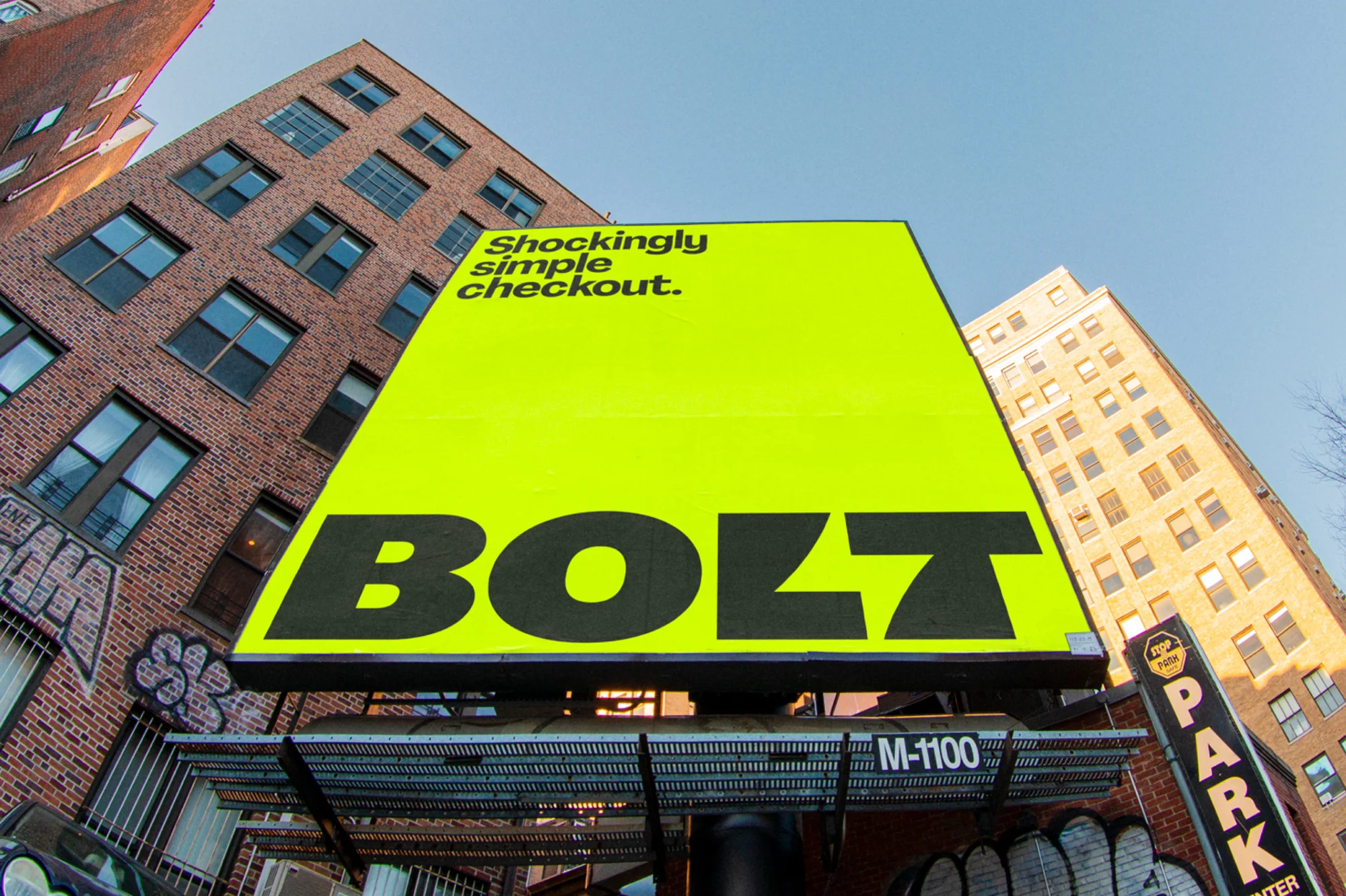 Large outdoor advertising billboard for Bolt checkout service with modern architecture and blue sky in an urban environment.