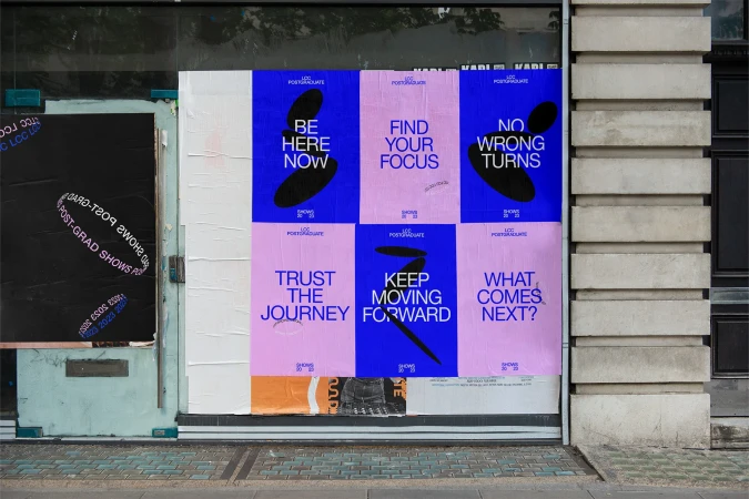 Posters with bold typography in shades of pink and blue are affixed to a building's exterior, advertising LCC Postgraduate Shows for 2023.
