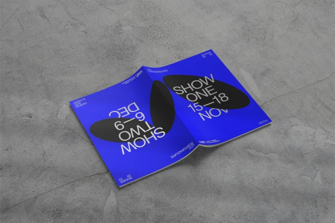 Open brochure on a gray surface featuring 'SHOW ONE' from November 15-18 and 'SHOW TWO' from December 6-9 in bold black text.