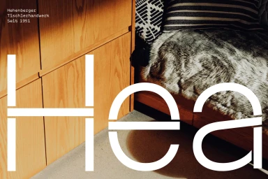 Wooden cabinets with large white geometric typography overlay and textured throw blanket on wooden bench
