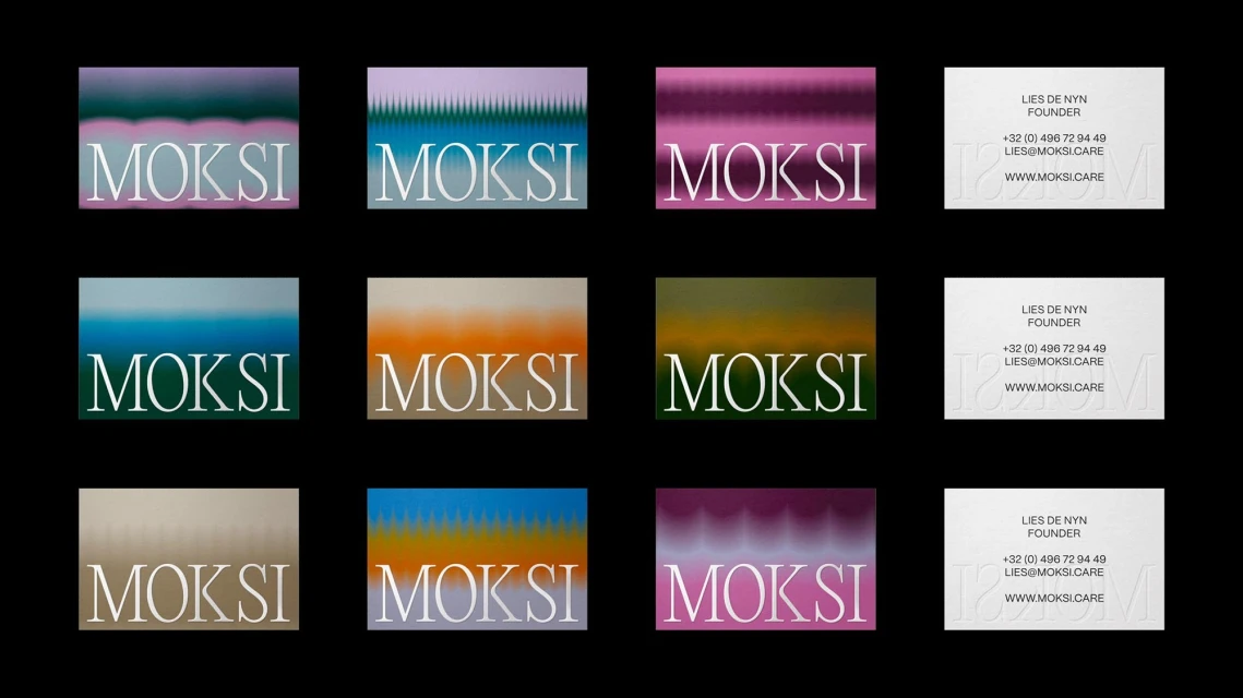 Arrangement of business cards featuring a colorful abstract background and 'Moksi' text, alongside contact details.