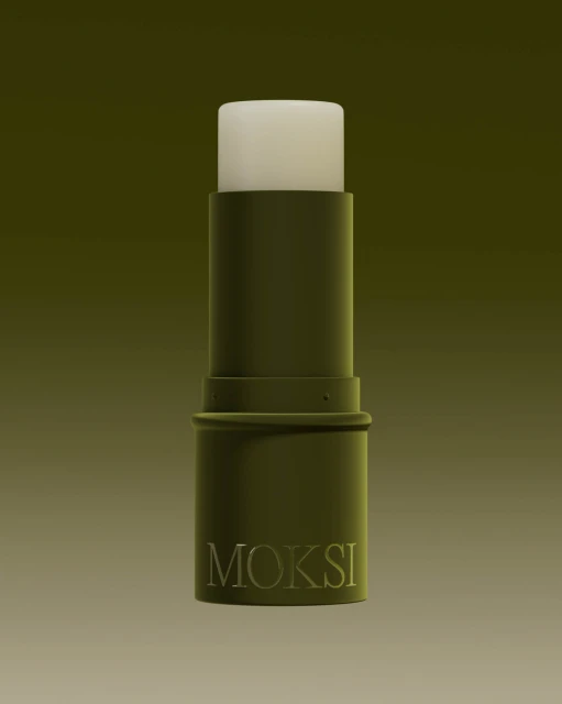 Close-up of an olive-green Moksi lip balm tube against a gradient background, showcasing minimalist design and neutral tones.