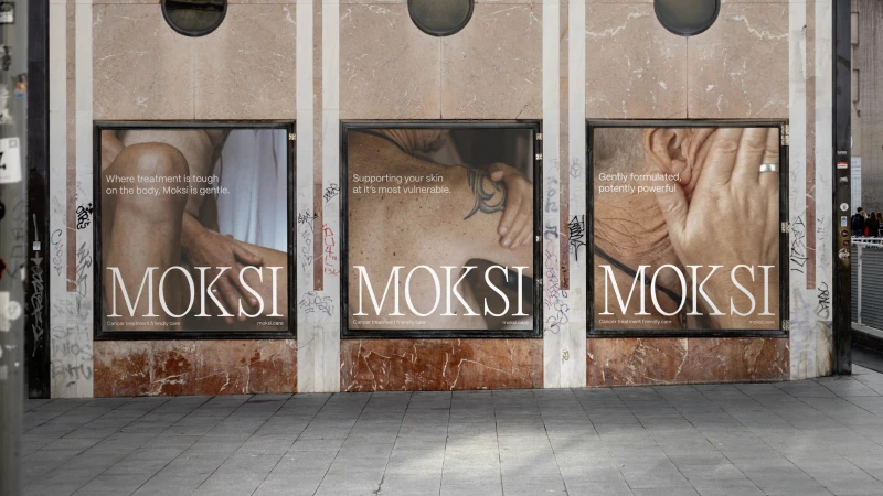 Three posters display Moksi brand cancer treatment products on a street in an urban environment, promoting cancer treatment friendly care.