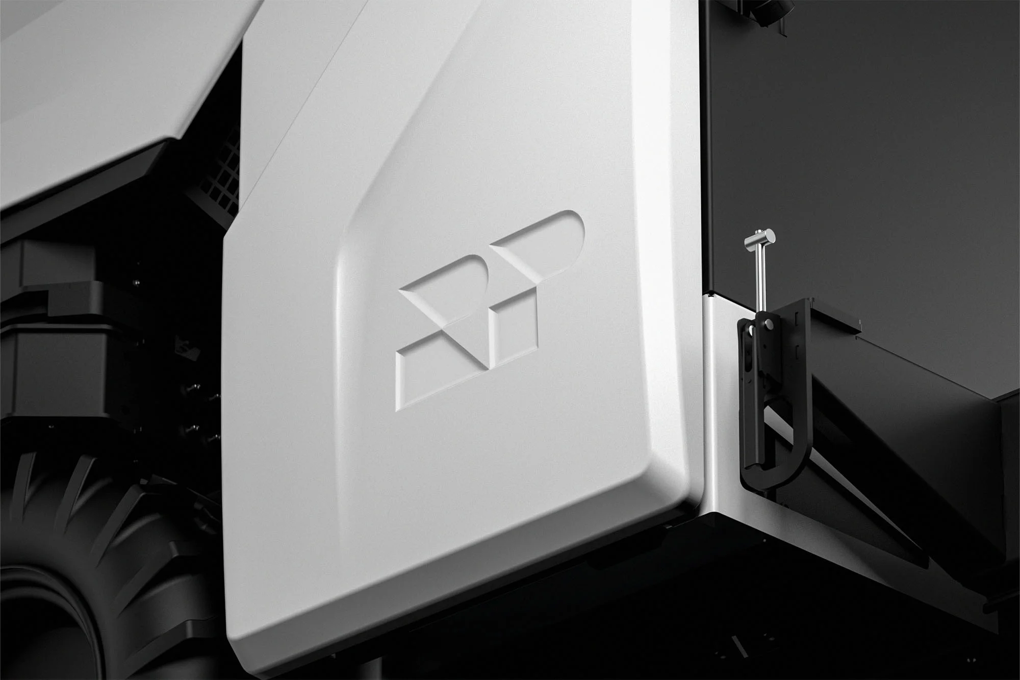 Close-up of a white autonomous vehicle featuring a tire and a geometric logo, set against a grey and black background.