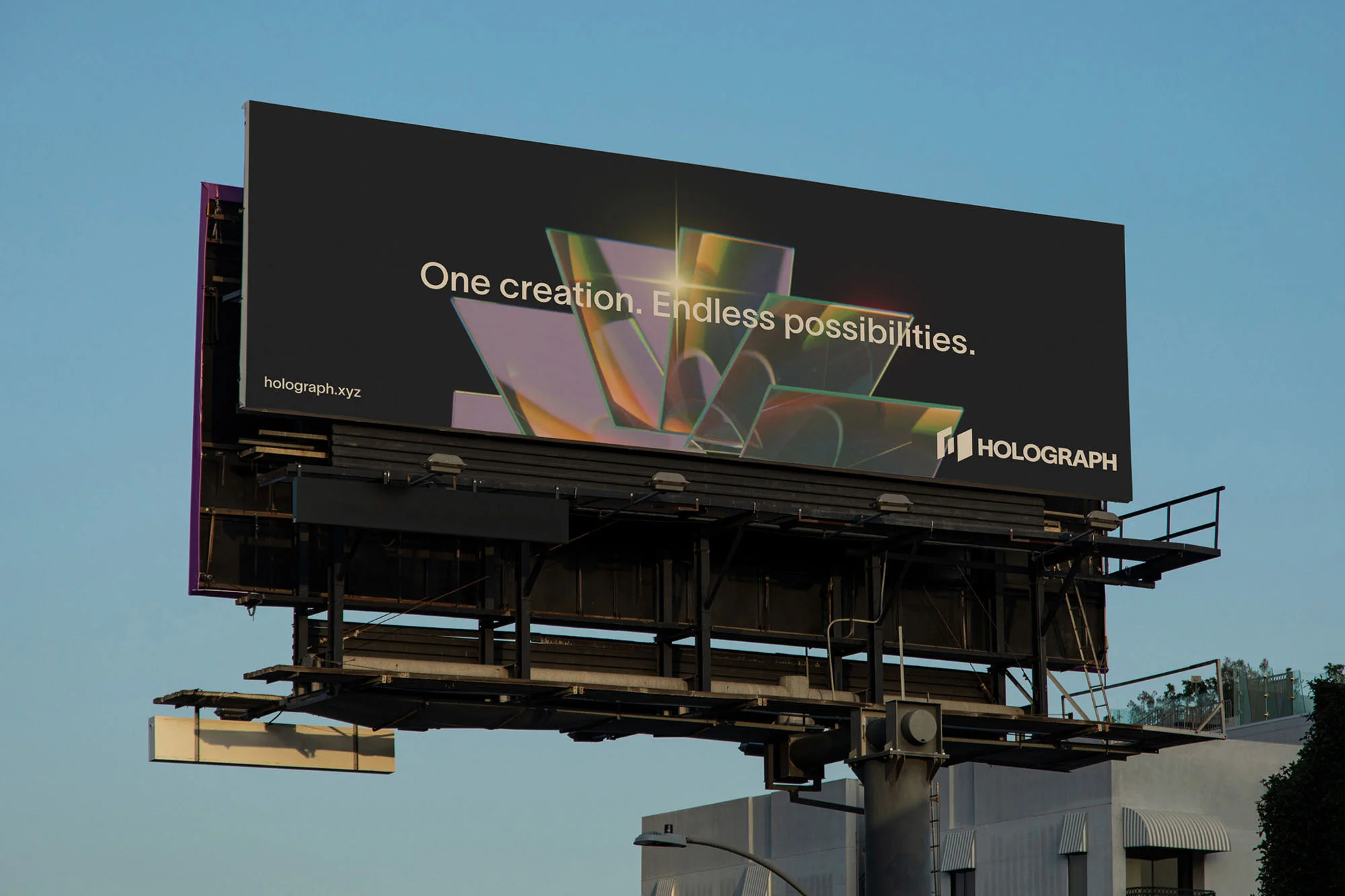 Billboard advertisement against a blue sky features abstract art and text for Holograph, a tech company. Outdoor advertising.