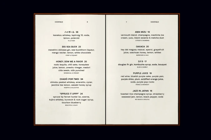 A cocktail menu displays a selection of mixed drinks with ingredients and descriptions in a framed presentation on a dark backdrop.
