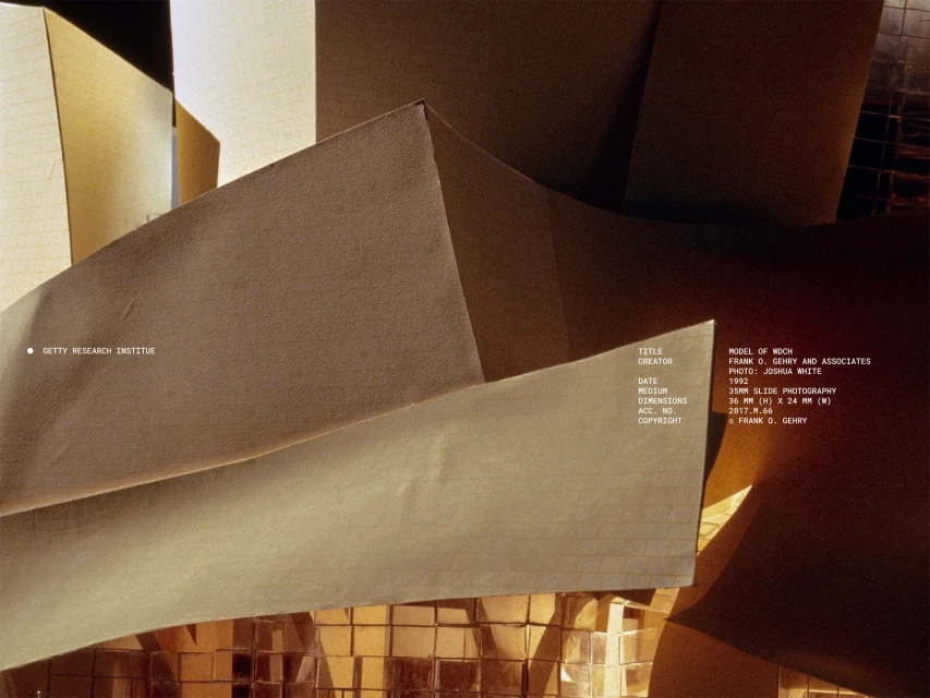 Architectural model of a building with light brown angular planes and geometric shapes, created by Frank Gehry and Associates in 1992.