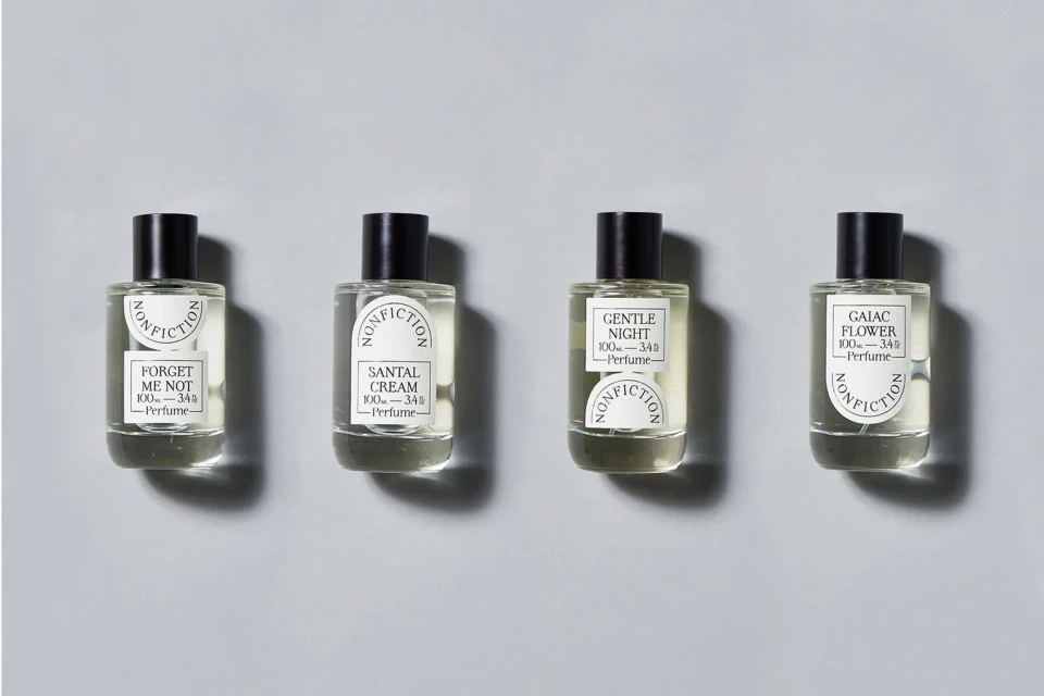 Four perfume bottles from Nonfiction brand on a light background, showcasing product photography, minimalist style, and beauty industry focus.