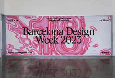 Large framed banner for Barcelona Design Week 2023 with pink abstract graphics and bold typography on a white background.