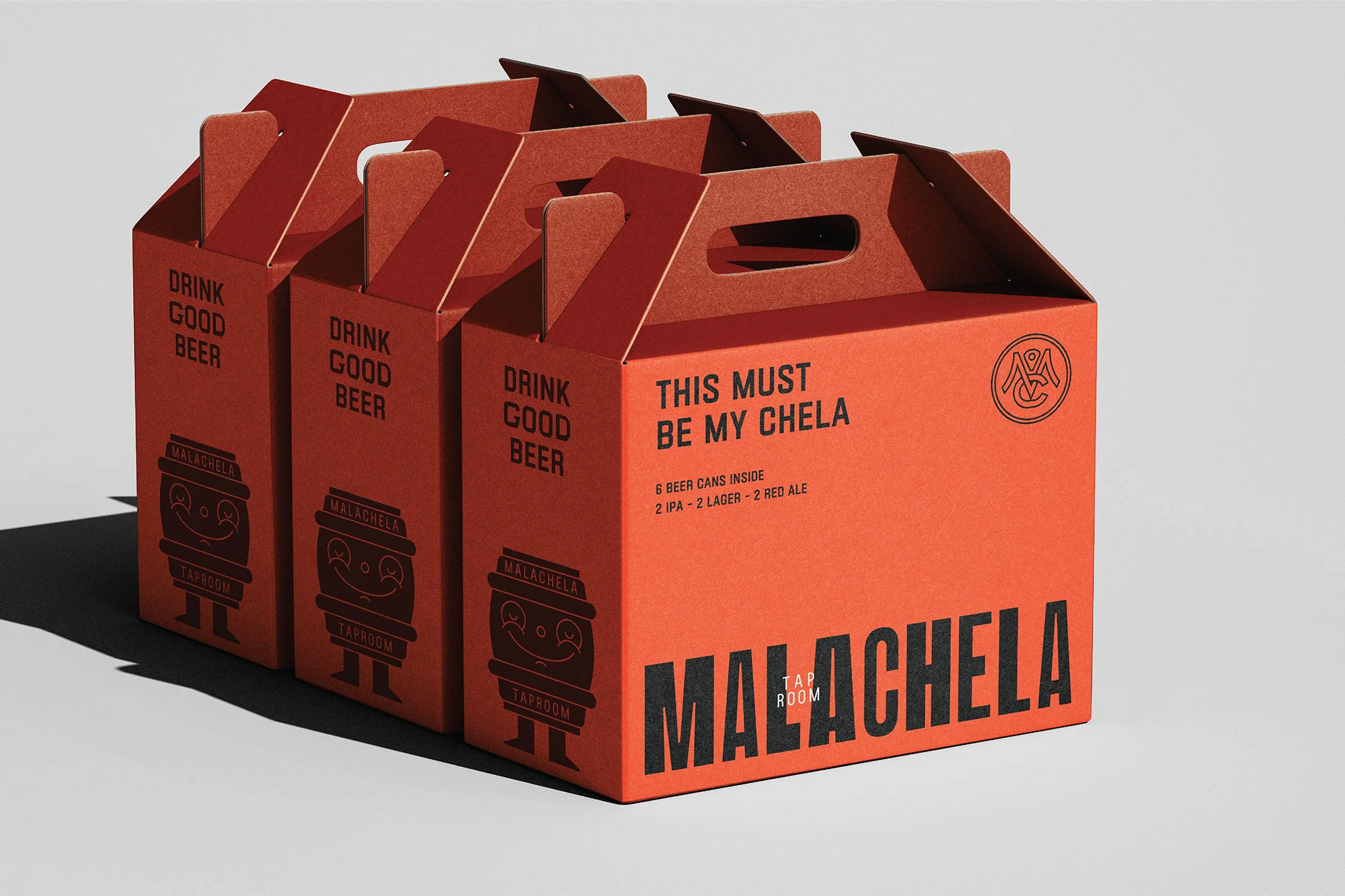 Three orange beer boxes with the words 'Drink Good Beer' and 'This Must Be My Chela' stacked on a plain background.