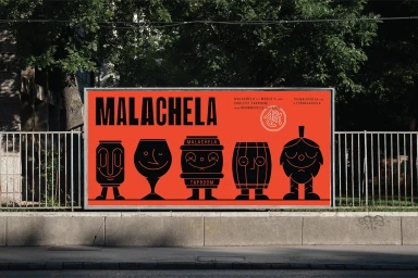 A billboard displaying Malachela brand identity with bold black graphics on an orange background behind a metal railing.