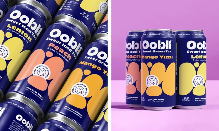 Multiple Oobli sweet iced tea cans in lemon, peach, mango and yuzu flavors with a navy blue background and pastel pink backdrop.