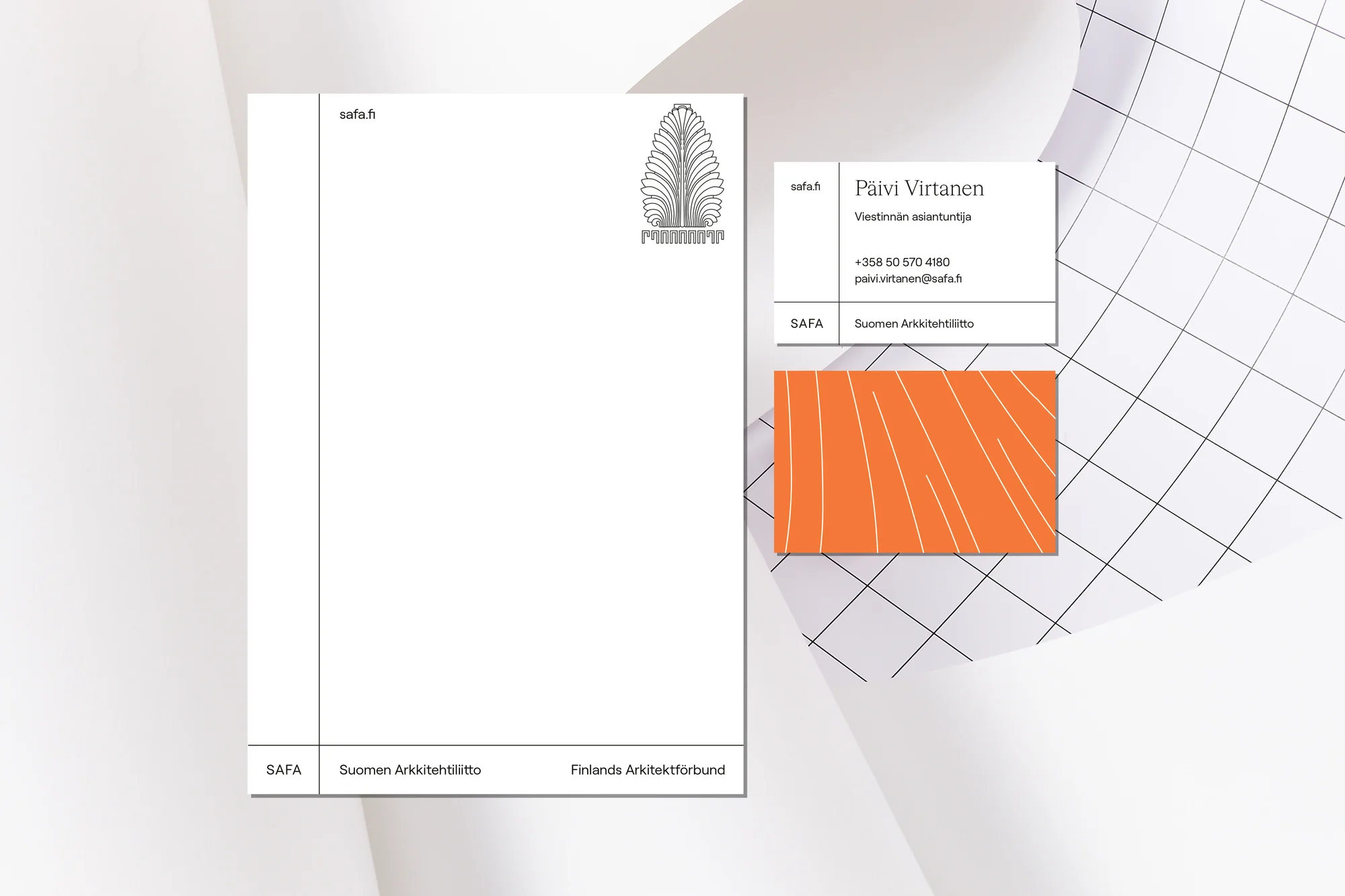 Promotional image of stationery featuring a letterhead and business card with minimalist design and orange accent card.  