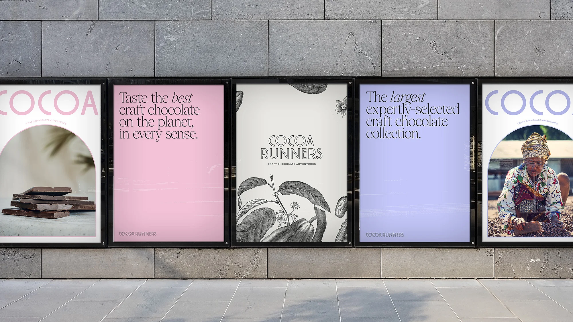 Five Cocoa Runners craft chocolate posters on a grey brick wall display various designs promoting chocolate adventures.