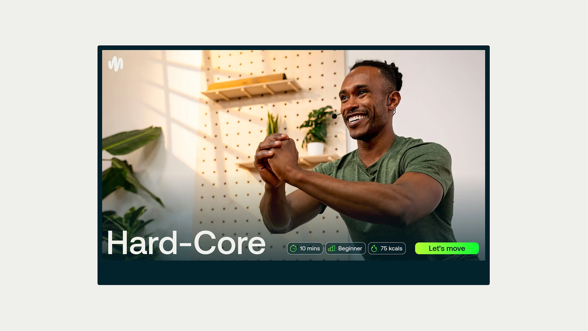 African-American male fitness instructor demonstrating hard-core workout routine at home, wearing headset and athletic wear.