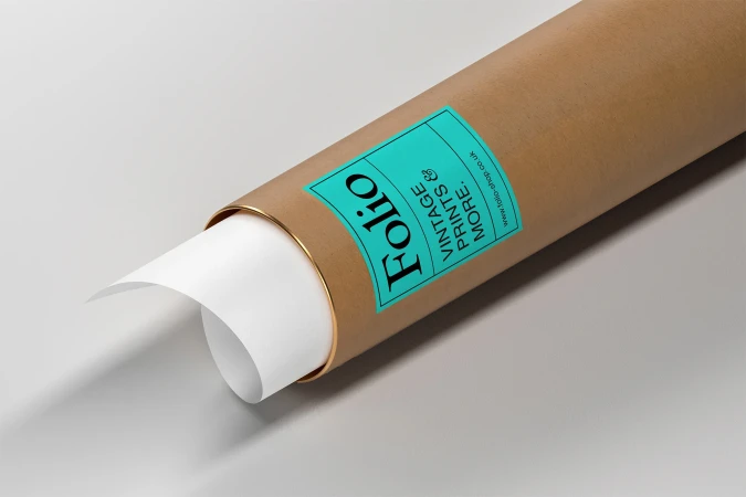 Cardboard mailing tube with teal label and rolled white paper sheet on a light grey background.